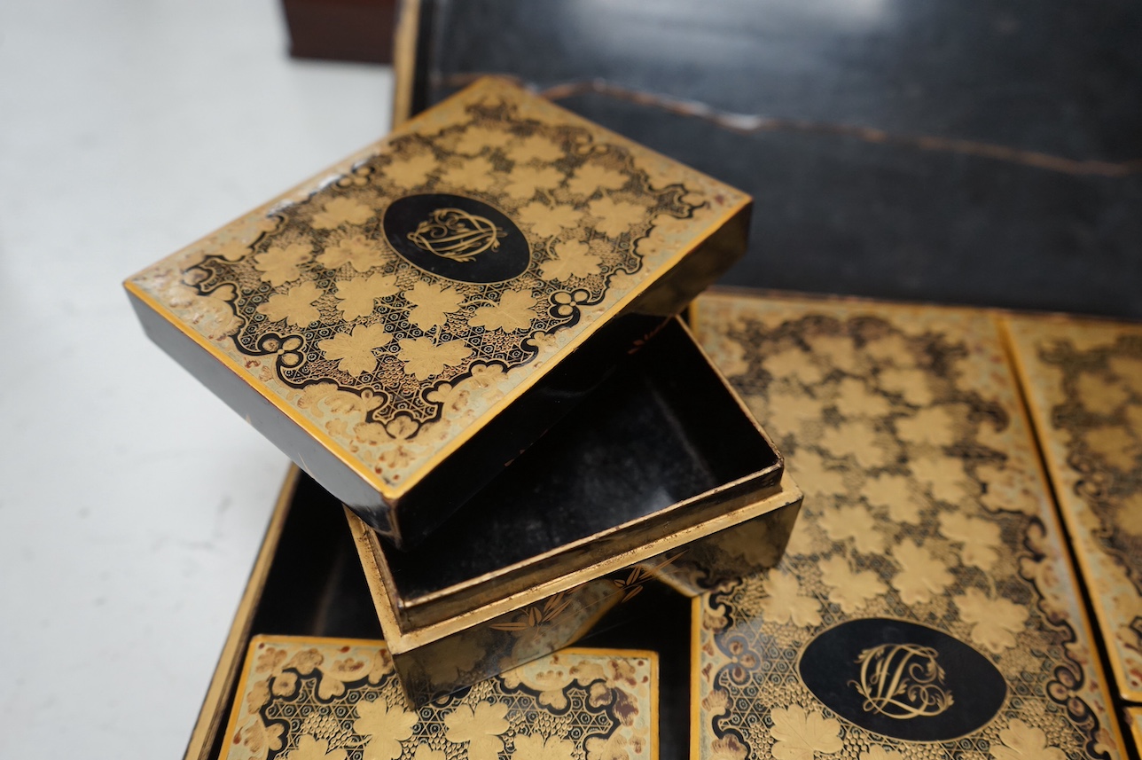 A mid 19th century Chinese gilt decorated and black lacquer games box, with five internal gilt and lacquered boxes, 30cm wide x 26cm deep. Condition - outer box split to top, gilding worn, edges worn, interior boxed as n